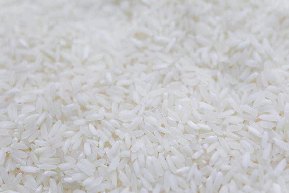 A detailed close-up shot of uncooked white rice grains, emphasizing texture and natural quality.